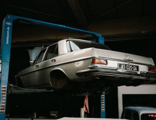 A classic Mercedes-Benz elevated in a car workshop, perfect for automotive themes.