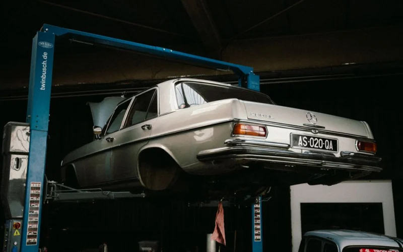 A classic Mercedes-Benz elevated in a car workshop, perfect for automotive themes.