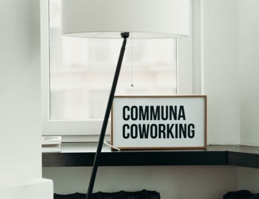 Simple and elegant coworking space decor with soft lamp lighting and window view.