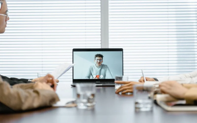 A diverse group participates in a virtual meeting using modern technology.