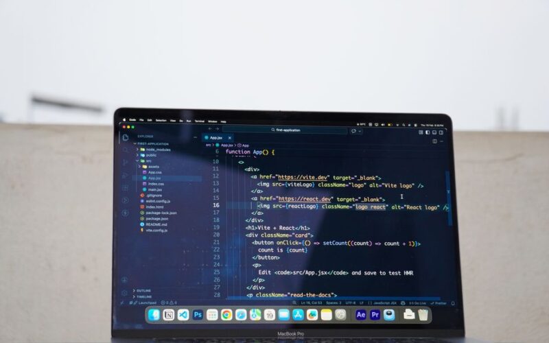 Laptop displaying code outdoors, ideal for remote work or freelance programming.
