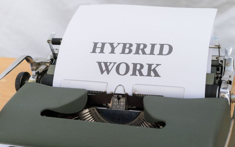 a typewriter with a paper that reads hybrid work