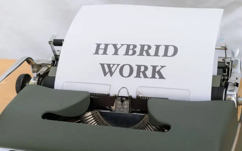 a typewriter with a paper that reads hybrid work