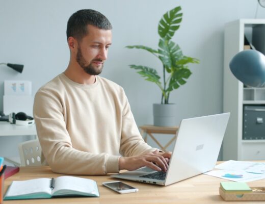 Man working on laptop at a desk.