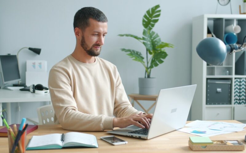Man working on laptop at a desk.