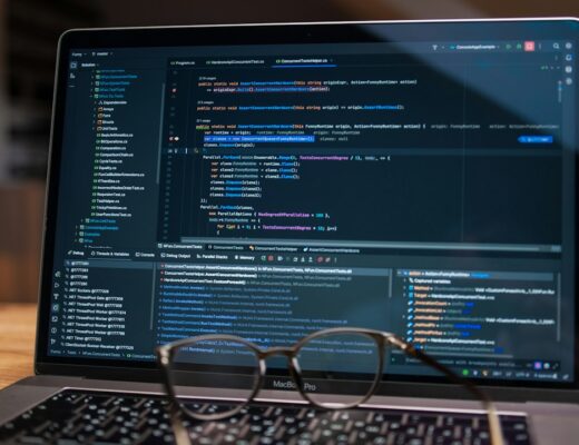 Laptop screen displaying lines of code with glasses