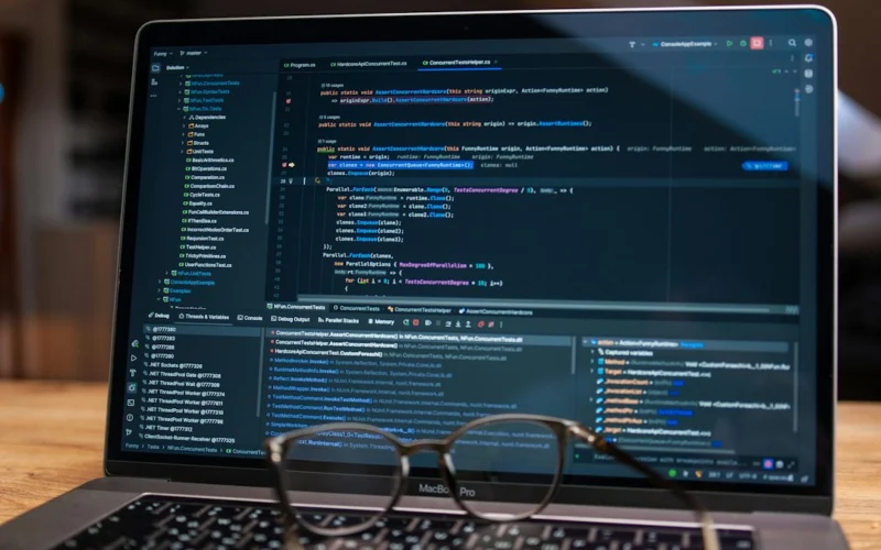 Laptop screen displaying lines of code with glasses