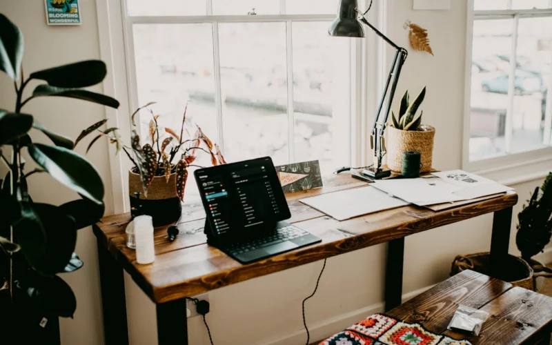 a laptop computer sitting on top of a wooden desk